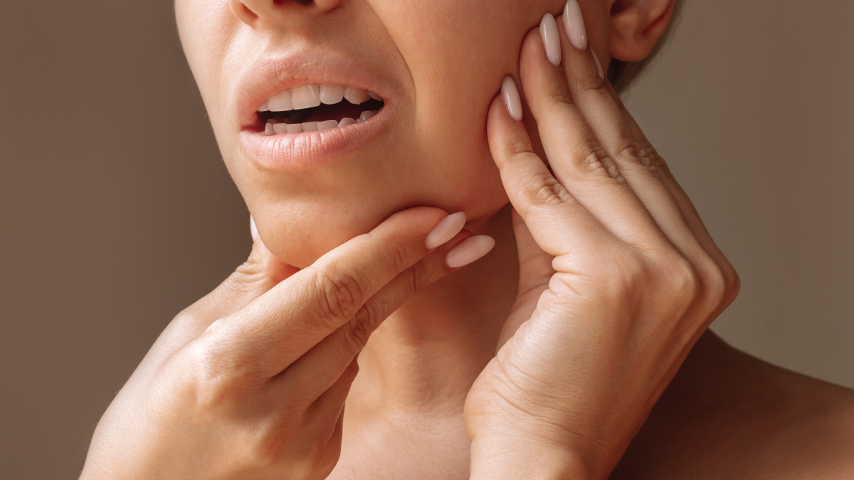 girl touching her jaw